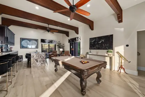 Game room with pool table and high ceilings