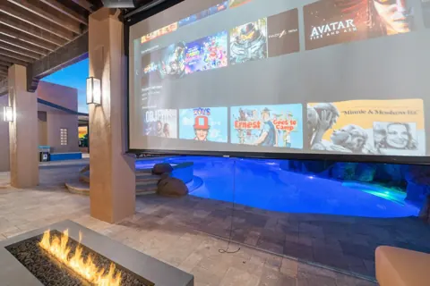 Outdoor screen setup beside the pool