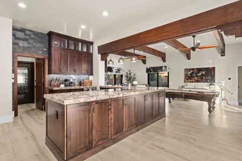 Chef’s kitchen with oversized island and warm wood cabinetry