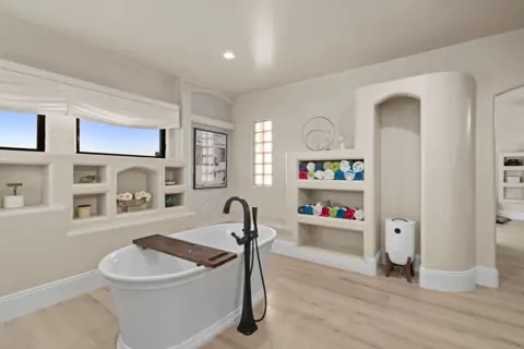 Spa-style bathroom with soaking tub and double vanities