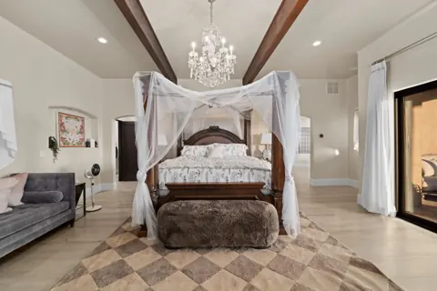 Spacious primary suite with canopy bed