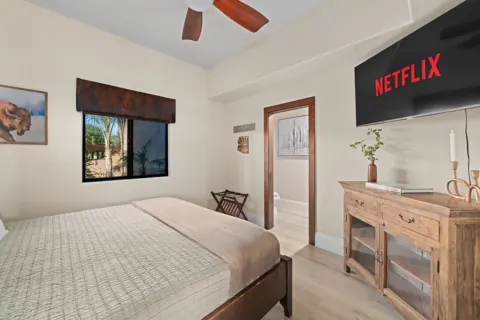 Guest bedroom with natural light and soft bedding