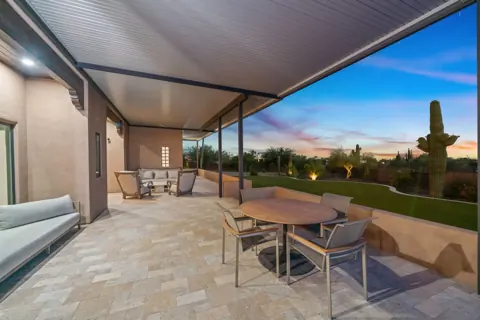 Covered patio dining area by the pool