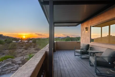 Covered patio with sunset and pool views