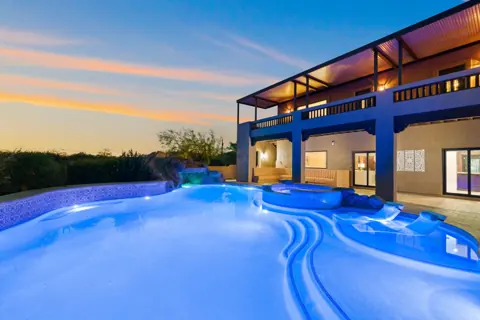 Resort-style pool and patio after dark