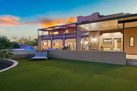 Covered patio and pool area at sunset