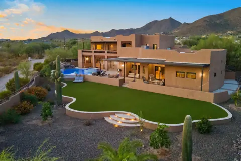 Large backyard with turf, pool, and covered patio