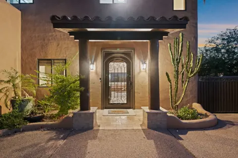 Dramatic front door with warm evening lights