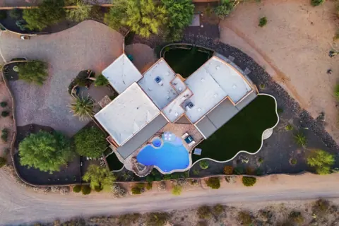 Full property aerial with pool, patio, and turf