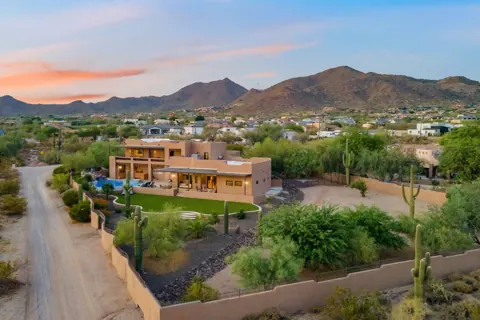 Aerial view of the home and surrounding mountains
