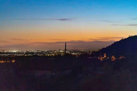 City lights and sunset views in the distance