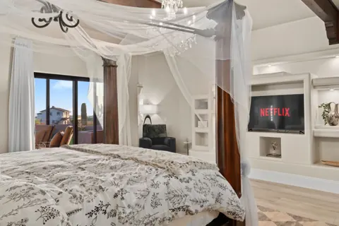 Romantic canopy bed with bright natural light