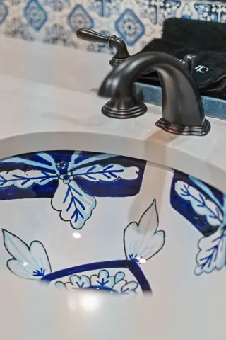 Decorative tile and black faucet detail