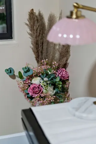 Soft floral decor and bedside styling