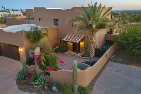 Charming courtyard entry with lush landscaping