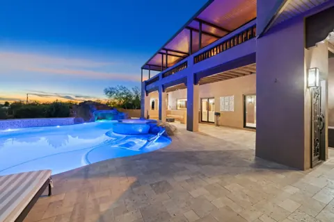 Twilight pool view with beautiful outdoor lighting