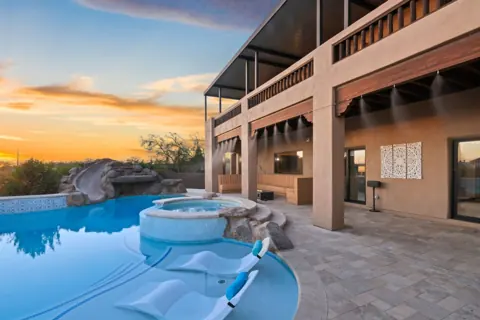 Spa and pool framed by desert landscaping