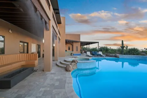 Poolside seating with evening sky views