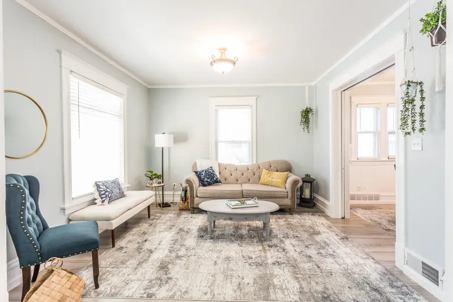 Serenity Sauna Retreat living room with a tufted sofa and a blue armchair