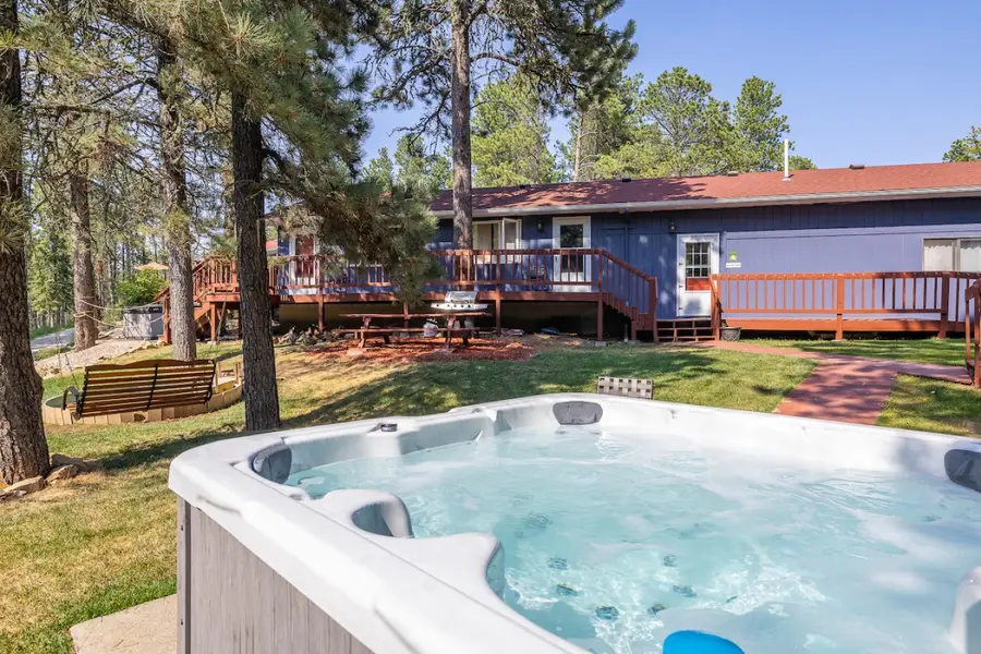 Shared hot tub on the lawn, with the main building behind