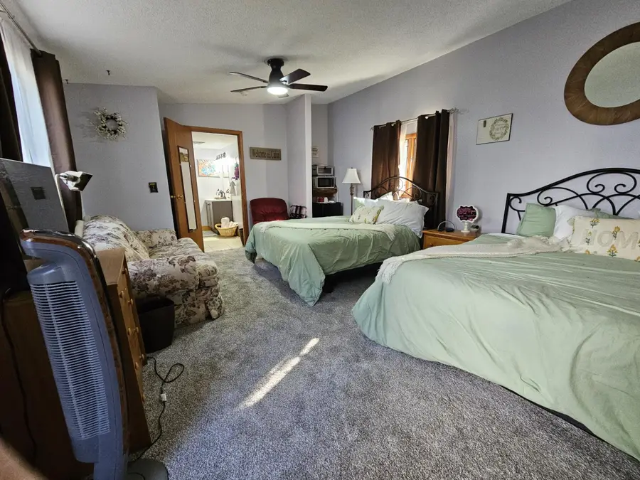 The Timber & Steam studio with two queen beds and a ceiling fan