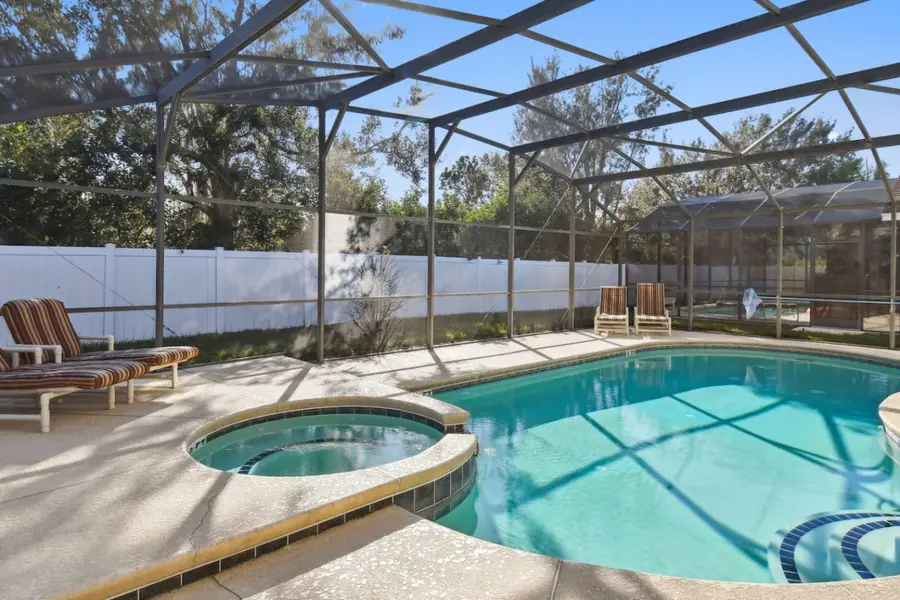 Sun-Kissed Sanctuary’s screened private pool and hot tub