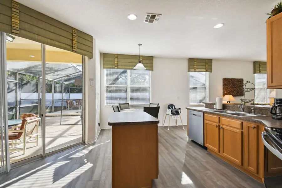 Kitchen island beside sliding doors that open to the screened pool
