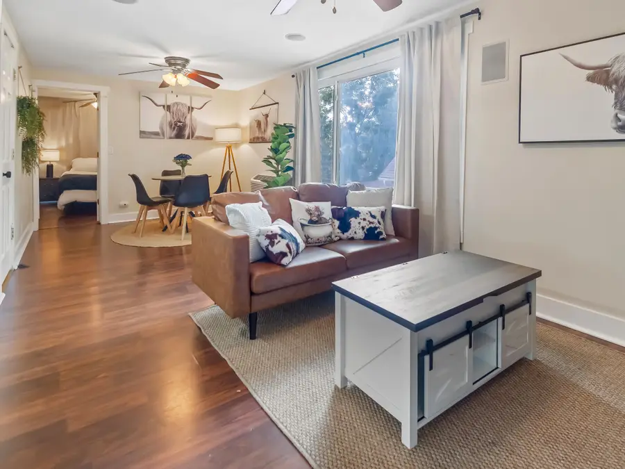 The Perch living room with a leather sofa and a white coffee table